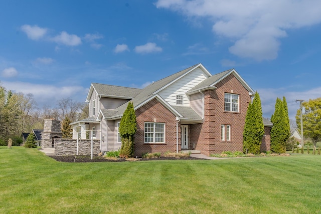 traditional-style house with roof with shingles, brick siding, and a front lawn