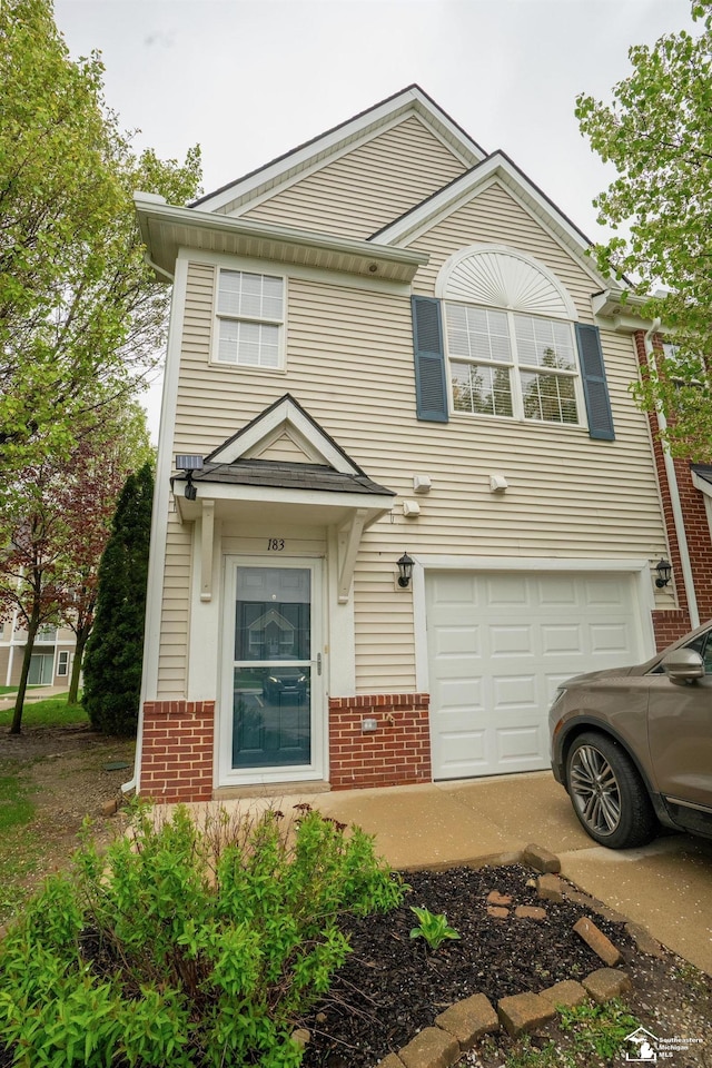 view of front of house with an attached garage and brick siding
