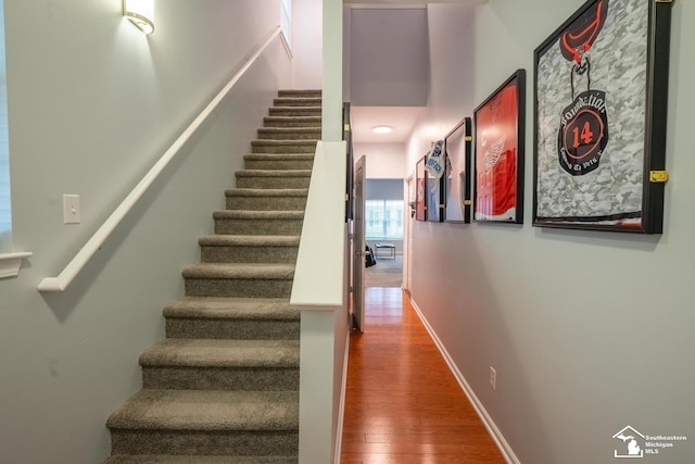 stairway with wood finished floors