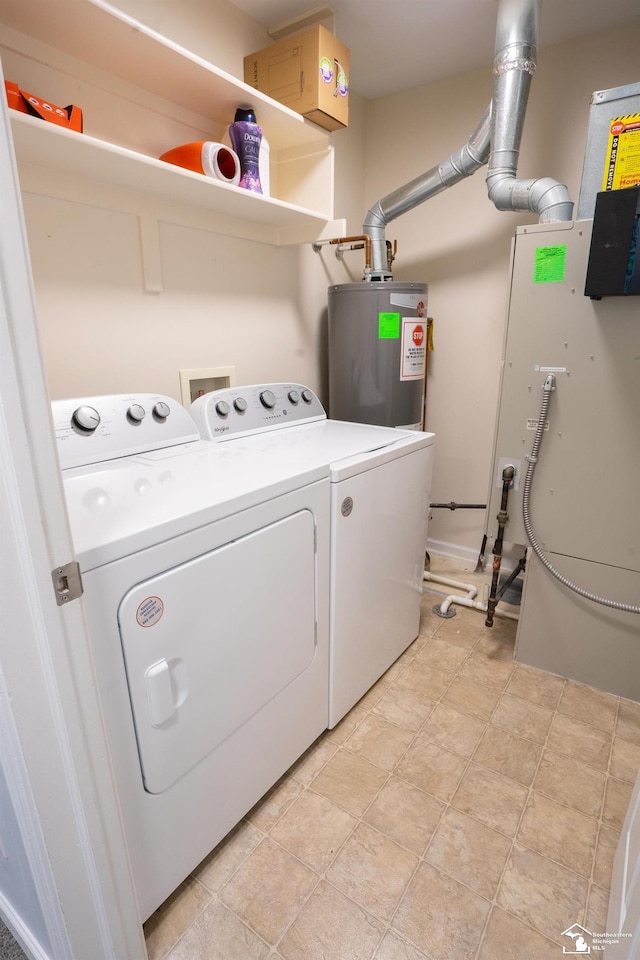 clothes washing area with washer and dryer, laundry area, and water heater