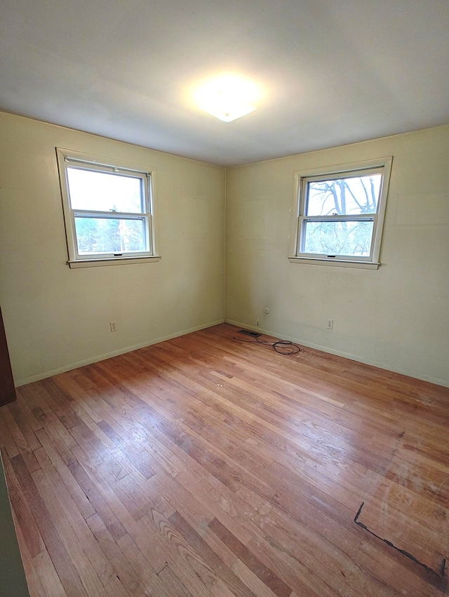 3385 Muerknoll Dr, Troy, MI 48084 - unfurnished room with healthy amount of natural light, wood finished floors, and baseboards