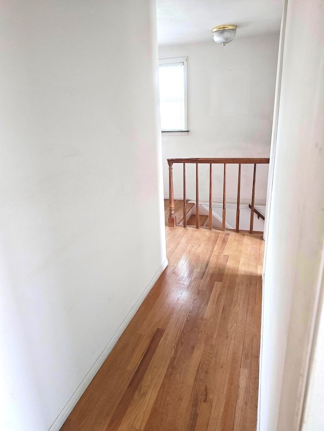 3385 Muerknoll Dr, Troy, MI 48084 - hall with wood-type flooring, baseboards, and an upstairs landing