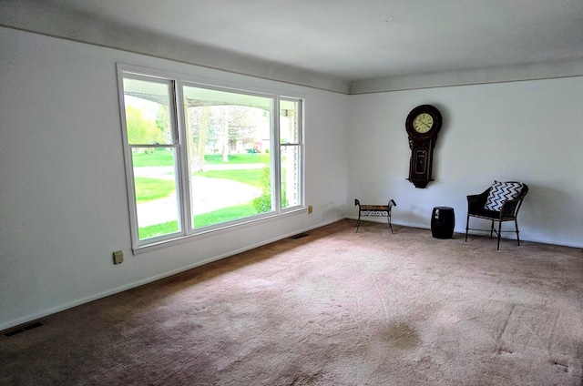 unfurnished room featuring baseboards, visible vents, and carpet floors