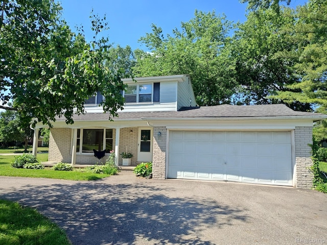3385 Muerknoll Dr, Troy, MI 48084 - view of front of home featuring asphalt driveway, a porch, a garage, and brick siding