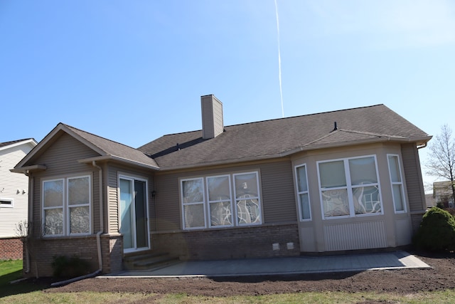 24179 Charlevoix St, Flat Rock, MI 48134 - rear view of property with entry steps, a chimney, and brick siding