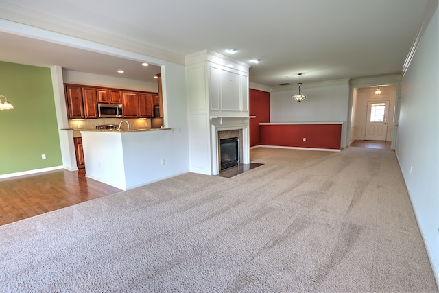 24179 Charlevoix St, Flat Rock, MI 48134 - unfurnished living room featuring crown molding, carpet floors, a high end fireplace, baseboards, and recessed lighting