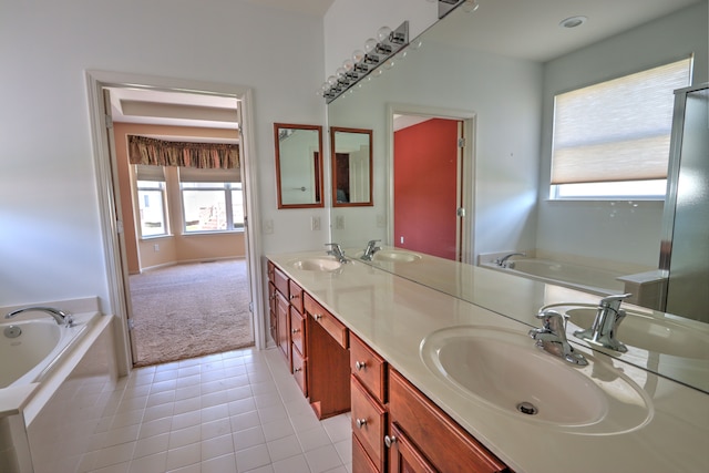 24179 Charlevoix St, Flat Rock, MI 48134 - full bathroom with double vanity, a bath, healthy amount of natural light, and tile patterned flooring