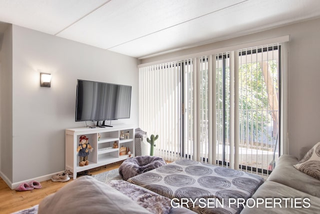 bedroom featuring baseboards and wood finished floors