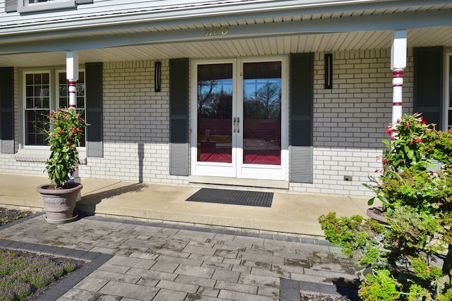 5100 Kings Gate Way, Bloomfield Hills, MI 48302 - view of exterior entry with brick siding, french doors, and a porch