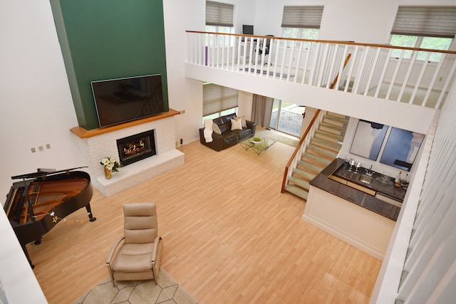5100 Kings Gate Way, Bloomfield Hills, MI 48302 - living room featuring wood finished floors, a brick fireplace, and a high ceiling