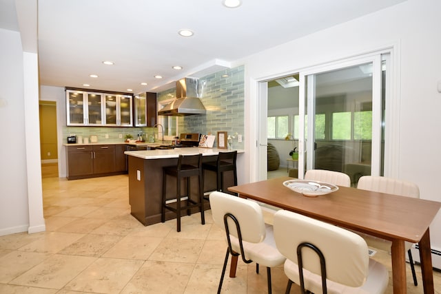 5100 Kings Gate Way, Bloomfield Hills, MI 48302 - kitchen with wall chimney exhaust hood, stainless steel range, light countertops, a peninsula, and glass insert cabinets