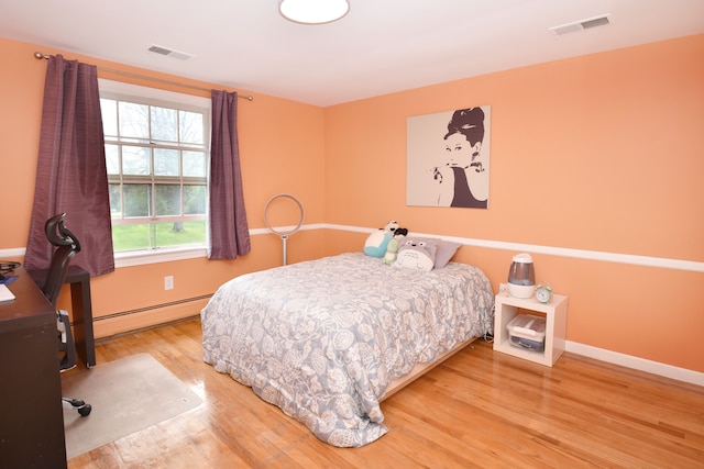 5100 Kings Gate Way, Bloomfield Hills, MI 48302 - bedroom with a baseboard radiator, wood finished floors, and baseboards