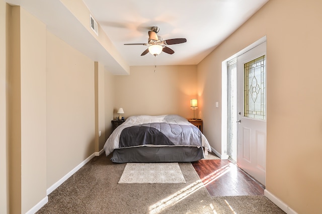 4780 Dutcher Rd, Howell, MI 48843 - carpeted bedroom with ceiling fan, baseboards, visible vents, and wood finished floors