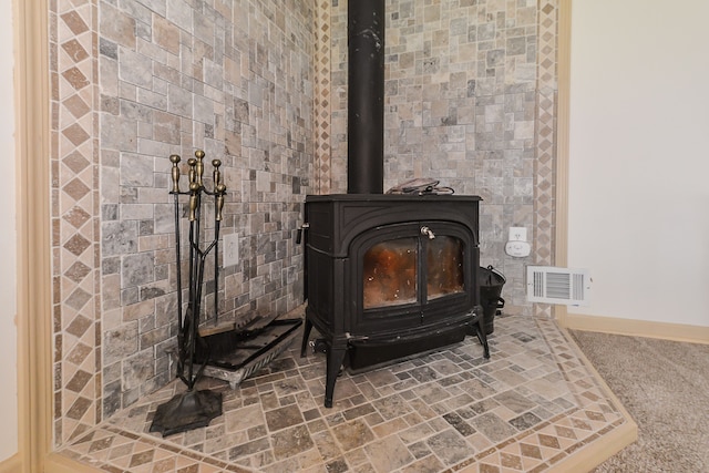 4780 Dutcher Rd, Howell, MI 48843 - interior details featuring a wood stove, baseboards, and visible vents