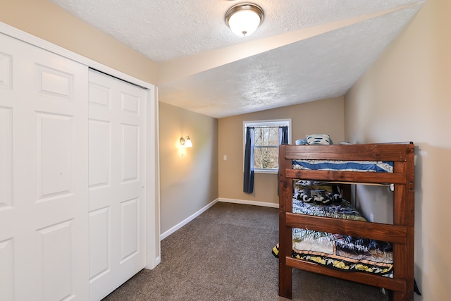 4780 Dutcher Rd, Howell, MI 48843 - bedroom with dark colored carpet, a textured ceiling, and baseboards