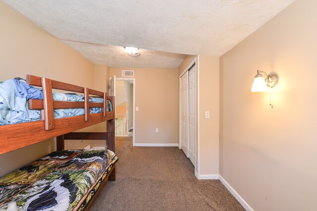 4780 Dutcher Rd, Howell, MI 48843 - carpeted bedroom featuring a textured ceiling, baseboards, a closet, and visible vents