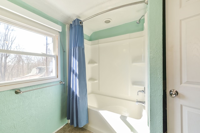 4780 Dutcher Rd, Howell, MI 48843 - full bathroom with a textured wall and shower / bath combination with curtain