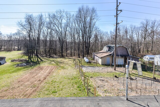 4780 Dutcher Rd, Howell, MI 48843 - view of yard with an outdoor structure, fence, a barn, and a detached garage
