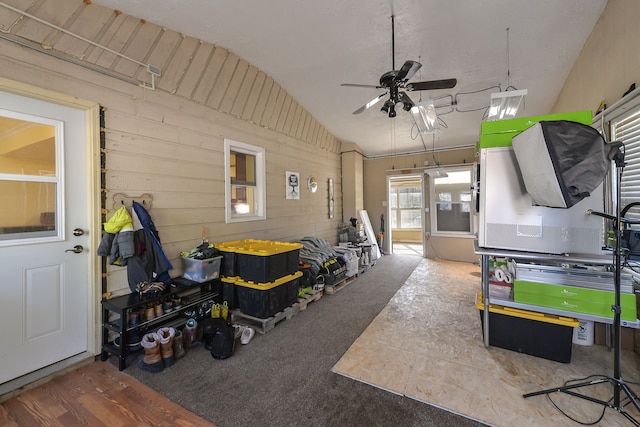4780 Dutcher Rd, Howell, MI 48843 - interior space featuring wood walls, ceiling fan, and vaulted ceiling