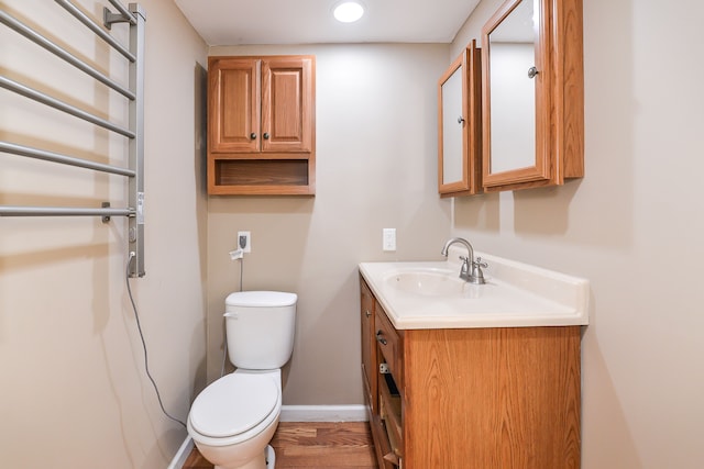 4780 Dutcher Rd, Howell, MI 48843 - bathroom with toilet, wood finished floors, baseboards, vanity, and recessed lighting