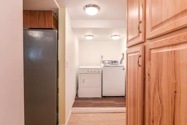 4780 Dutcher Rd, Howell, MI 48843 - washroom with laundry area, washer and clothes dryer, and light tile patterned flooring