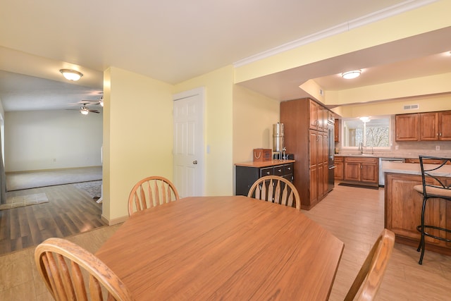 4780 Dutcher Rd, Howell, MI 48843 - dining area featuring ceiling fan, light wood-style floors, and visible vents