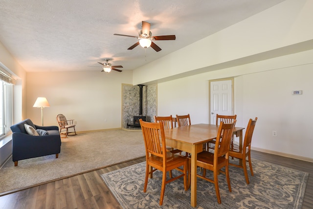 4780 Dutcher Rd, Howell, MI 48843 - dining room with a wood stove, wood finished floors, baseboards, and ceiling fan