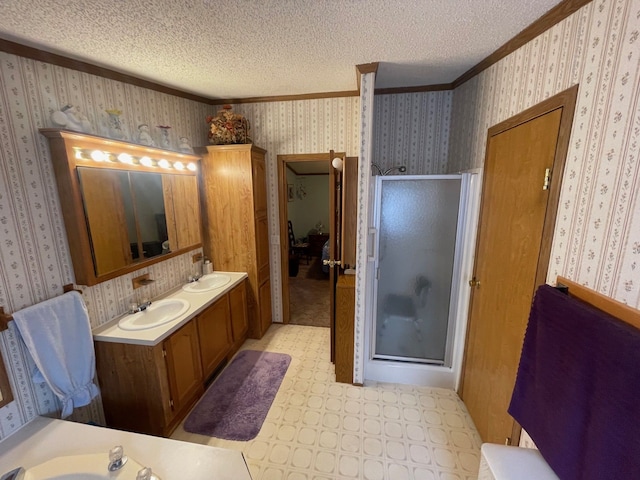 bathroom with wallpapered walls, ornamental molding, a stall shower, tile patterned floors, and double vanity