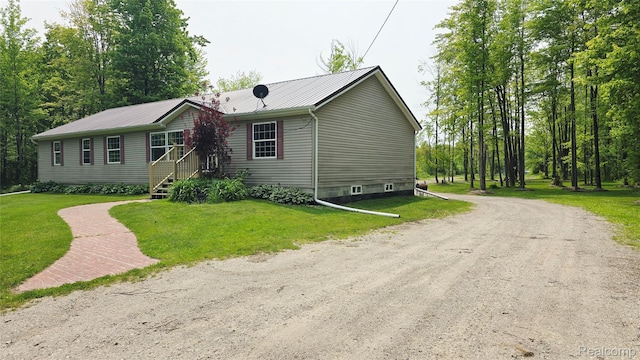 5303 Dove Rd, Kimball, MI 48074 - manufactured / mobile home with metal roof, a front yard, and driveway