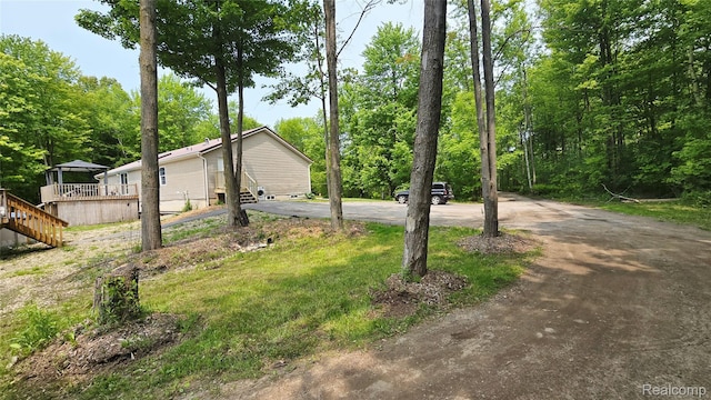 5303 Dove Rd, Kimball, MI 48074 - view of yard featuring asphalt driveway, a wooden deck, and entry steps