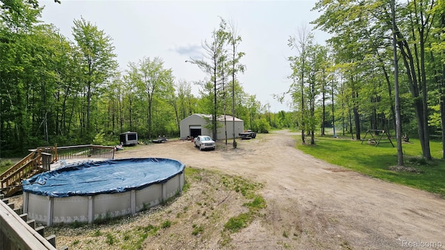 5303 Dove Rd, Kimball, MI 48074 - view of swimming pool featuring a covered pool, an outbuilding, and a wooden deck
