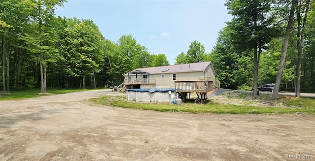 5303 Dove Rd, Kimball, MI 48074 - rear view of property with a deck, a covered pool, and stairway