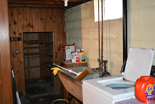 clothes washing area featuring laundry area and concrete block wall
