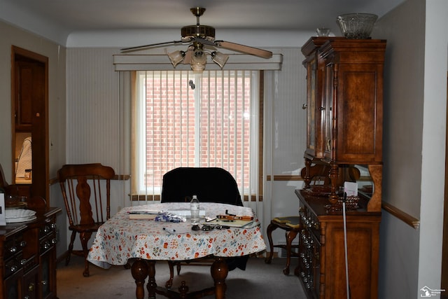 dining room with ceiling fan and carpet