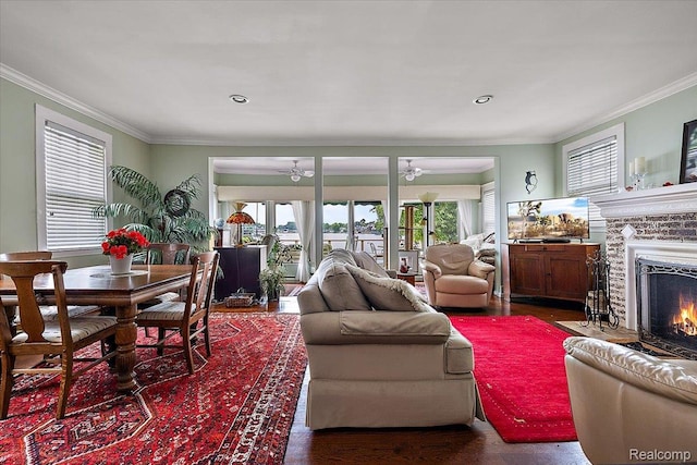 173 N N Shore Dr, Lake Orion, MI 48362 - living area featuring a ceiling fan, wood finished floors, a lit fireplace, crown molding, and recessed lighting