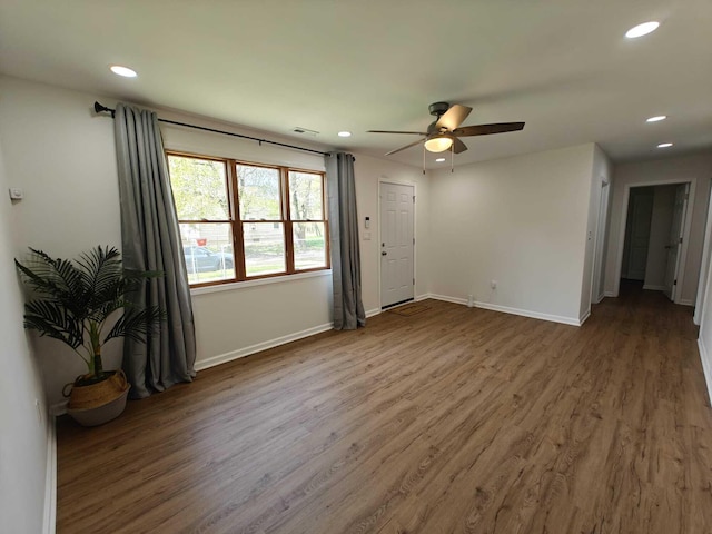 unfurnished room featuring wood finished floors, visible vents, recessed lighting, ceiling fan, and baseboards