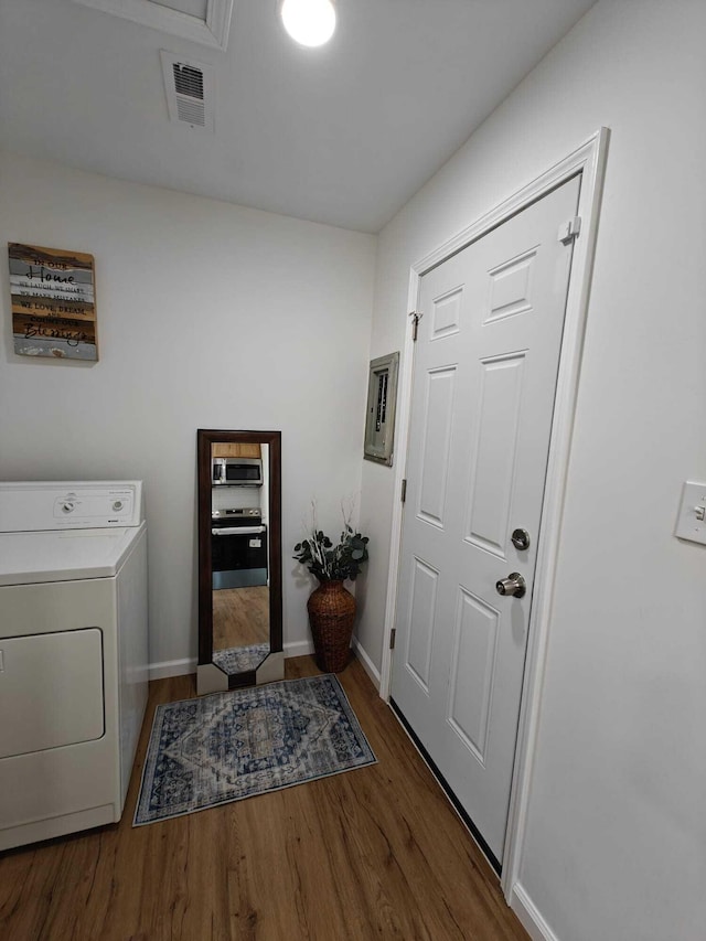 laundry room with washer / dryer, wood finished floors, laundry area, visible vents, and baseboards