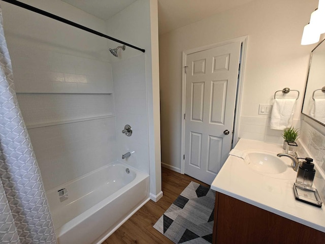 full bathroom featuring vanity, shower / tub combo, and wood finished floors