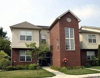 28848 5 Mile Rd Unit 11, Livonia, MI 48154 - traditional-style home with a front yard and brick siding