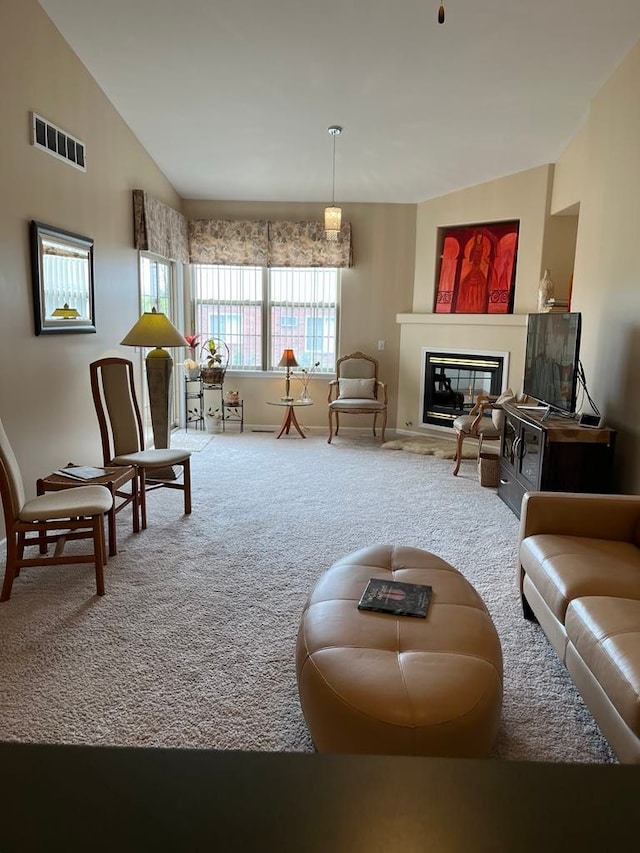28848 5 Mile Rd Unit 11, Livonia, MI 48154 - carpeted living area with vaulted ceiling, a glass covered fireplace, baseboards, and visible vents