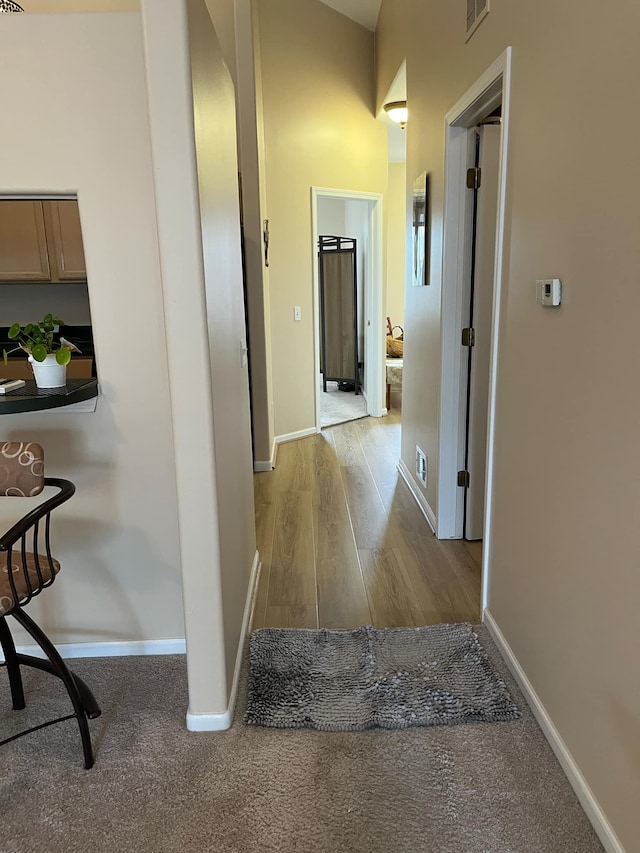 28848 5 Mile Rd Unit 11, Livonia, MI 48154 - hallway featuring baseboards, visible vents, and wood finished floors