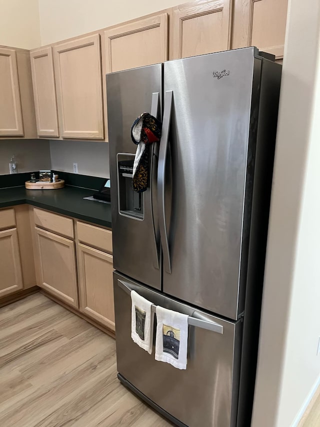 28848 5 Mile Rd Unit 11, Livonia, MI 48154 - kitchen featuring dark countertops, stainless steel refrigerator with ice dispenser, and light wood-style floors