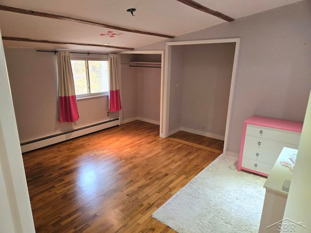 8570 Hornbeam Ln, Saginaw, MI 48603 - unfurnished bedroom featuring a baseboard heating unit, vaulted ceiling, wood finished floors, and baseboards