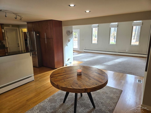 8570 Hornbeam Ln, Saginaw, MI 48603 - living room with a baseboard radiator, light wood-style floors, a baseboard heating unit, recessed lighting, and rail lighting