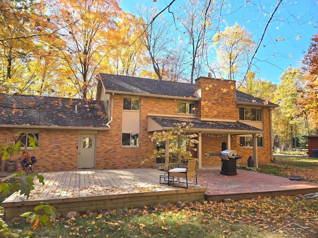 8570 Hornbeam Ln, Saginaw, MI 48603 - rear view of property with a chimney, brick siding, and a deck