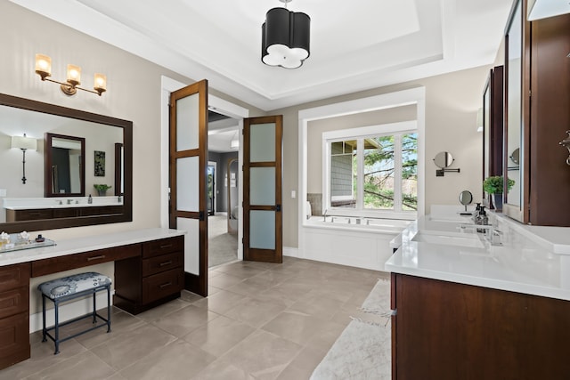 5744 Wyndam Ln, Brighton, MI 48116 - full bathroom featuring vanity, a tub, a chandelier, tile patterned flooring, and a tray ceiling