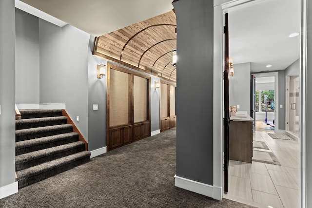 5744 Wyndam Ln, Brighton, MI 48116 - hallway with a sink, stairs, wood ceiling, and baseboards