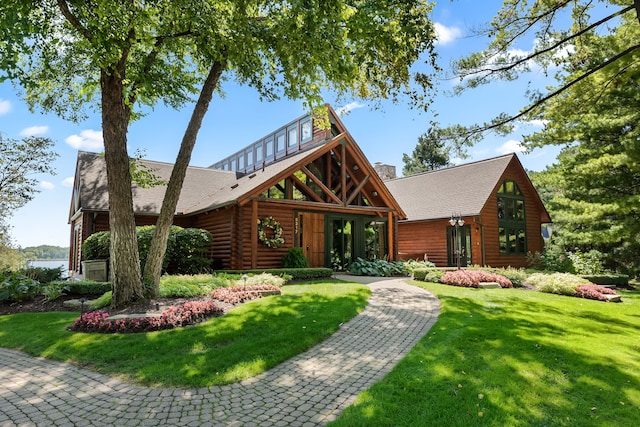 5744 Wyndam Ln, Brighton, MI 48116 - log-style house featuring roof with shingles, a chimney, log exterior, and a front yard