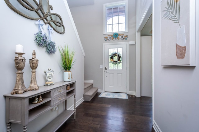foyer entrance with stairway, baseboards, and dark wood-style floors