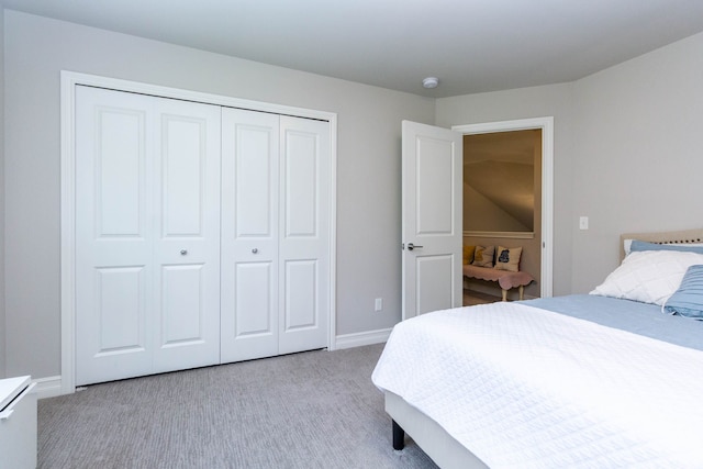 carpeted bedroom with baseboards and a closet